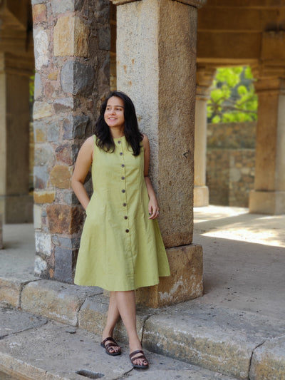 Model wearing sleeveless a-line lime green linen dress with button down front